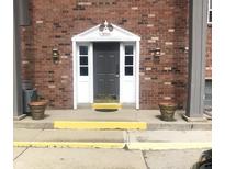 Inviting building entrance with brick exterior, and well-manicured landscaping at 3016 Lake Shore Dr # E, Indianapolis, IN 46205