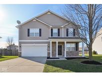 Two-story house with a neutral color scheme and stone accents at 3796 Indigo Blue Blvd, Whitestown, IN 46075