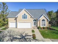 Two-story house with a beige exterior, grey roof, and a two-car garage at 4770 Winterberry Pl, Columbus, IN 47201