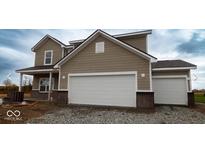 Two-story house with taupe siding, white trim, and a two-car garage at 5691 Volanti Way, Greenwood, IN 46143