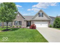 Brick ranch home with 2-car garage, landscaping, and a large front yard at 14144 Stoney Shore Ave, McCordsville, IN 46055