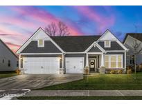 Gray-toned two-story house with white accents, two-car garage, and manicured lawn at 18943 Karyn Ln, Noblesville, IN 46062