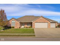 Brick ranch home with 2-car garage, landscaping, and a charming front entrance at 5138 Imperial Dr, Columbus, IN 47203