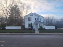 Two-story white house with dark accents and a landscaped lawn at 1104 S Harrison St, Alexandria, IN 46001