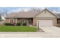 Brick ranch house with attached garage and landscaped lawn at 12321 Brompton Rd, Carmel, IN 46033