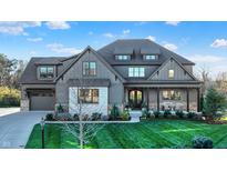 Gray two-story house with white accents, landscaping, and a three-car garage at 16334 River Crest Ct, Westfield, IN 46062