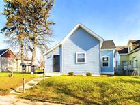 Newly renovated light blue home with a well-manicured lawn at 1814 Fairview St, Anderson, IN 46016