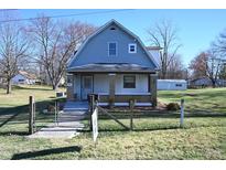 Cute gray house with a large yard and a charming front porch at 3235 Adams St, Indianapolis, IN 46218