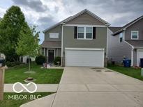 Two-story house with attached garage and well-maintained lawn at 7720 Bolero Dr, Camby, IN 46113