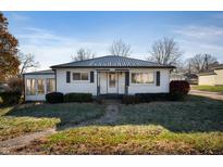 Charming white house with a metal roof and a sunroom at 9833 W Main St, Lapel, IN 46051