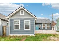 Gray house with white trim, a blue door, and a small front yard at 359 Terrace Ave, Indianapolis, IN 46225