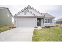 Gray house with white accents, a two-car garage, and a landscaped lawn at 5607 Tart Blvd, Indianapolis, IN 46239