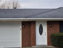 Brick ranch house with attached garage and landscaping at 734 Hattie Dr, Anderson, IN 46013