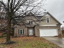 Charming two-story home with a brick and siding exterior, attached garage, and landscaping at 1036 Spanish Lake Dr, Avon, IN 46123