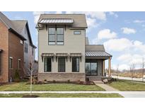 Modern two-story home with gray siding, metal roof, and brick accents at 17366 Newton Main St, Westfield, IN 46074