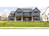 Two-story farmhouse with gray siding, stone accents, and a welcoming front porch at 5187 Abington Way, Zionsville, IN 46077