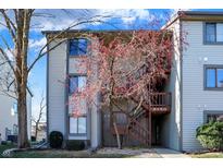 Two story condo building with wood stairs and neutral siding at 8150 Shorewalk Dr # B, Indianapolis, IN 46236