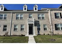 Brick townhouse exterior with a balcony and a neatly landscaped lawn at 2834 Maricopa Blvd, Whitestown, IN 46075