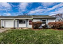 Ranch home with attached garage and well-manicured lawn at 8016 Minlo Dr, Indianapolis, IN 46227
