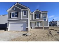 Two-story house with gray siding, white garage door, and brick accents at 3943 Seeger St, Indianapolis, IN 46239