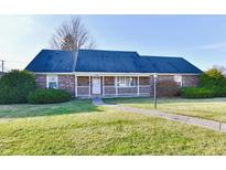 Brick ranch house with attached garage and landscaped yard at 1500 S Anderson St, Elwood, IN 46036