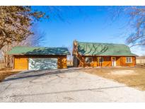 Charming log cabin home with attached garage and spacious yard at 4298 W 300 N, Anderson, IN 46011