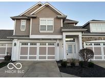 Two-story house with taupe siding, white trim, and a three-car garage at 581 Beehler Dr, Whiteland, IN 46184