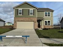 Two-story house with green siding, brick accents, and a two-car garage at 5601 Tart Blvd, Indianapolis, IN 46239