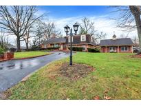 House exterior showcasing landscaping and a curving driveway at 6337 Cardinal Ln, Indianapolis, IN 46220