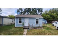 Cute bungalow with light blue siding, new windows, and a ramp for accessibility at 2914 Collier St, Indianapolis, IN 46241