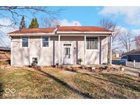 Ranch home with red roof, covered porch, and landscaped yard at 807 Alden Dr, Fortville, IN 46040