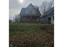 Two-story house with brick and siding, situated on a grassy lot at 1207 W 35Th St, Indianapolis, IN 46208