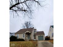 Tan single story home with attached garage and manicured lawn at 354 W 38Th St, Anderson, IN 46013