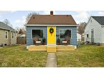 Charming bungalow with a yellow door, wooden deck, and well-manicured lawn at 4630 Young Ave, Indianapolis, IN 46201