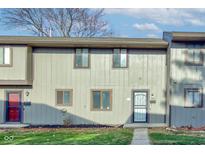 Attractive townhouse exterior with landscaping and a neat lawn at 7909 Benjamin Dr, Indianapolis, IN 46226