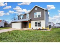 Two-story house with gray siding, white accents, and a yellow front door at 3826 Maple Manor Dr, Indianapolis, IN 46237