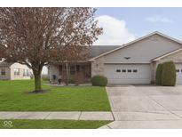 Brick ranch home with 2-car attached garage and landscaped lawn at 397 Camellia Ln, Bargersville, IN 46106