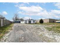 Ranch home with detached garage and driveway at 4925 W Raymond St, Indianapolis, IN 46241