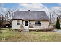 Beige house with gray roof, wooden deck, and steps at 6348 Kingsley Dr, Indianapolis, IN 46220