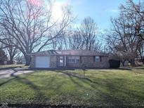 Brick ranch house with a spacious lawn and mature trees at 953 W Seybert St, Pendleton, IN 46064