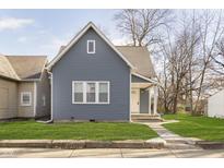 Gray house with white trim and a well-maintained lawn at 209 Trowbridge St, Indianapolis, IN 46201