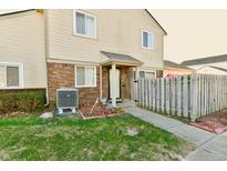 Front exterior view of a two-story home with a fenced yard and walkway at 4961 Oakbrook Dr # A1, Indianapolis, IN 46254