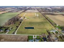 An aerial view showcasing a sprawling property with a race track, pond, and house at 432 500 N, Anderson, IN 46012