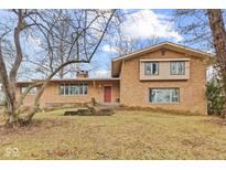 Brick ranch house with attached garage and landscaping at 4529 Dickson Rd, Indianapolis, IN 46226