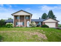 Charming two-story home with a landscaped front yard and attached garage at 4832 E 200 N, Anderson, IN 46012