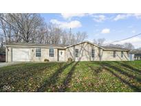 One-story home with attached two-car garage and large front yard at 1090 Robb Hill Rd, Martinsville, IN 46151