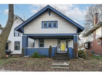Charming two-story home with a blue and white exterior and a bright yellow front door at 3458 N Kenwood Ave, Indianapolis, IN 46208