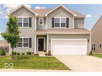 Two-story house with gray siding, white garage door, and landscaping at 13834 Keams Dr, Fishers, IN 46038