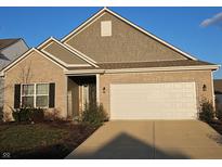 Brick ranch house with gray accents, a two-car garage, and landscaping at 4411 Ringstead Way, Indianapolis, IN 46235