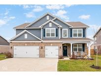 Two-story house with gray siding, brick accents, and a two-car garage at 4585 W Tradwell Dr, New Palestine, IN 46163